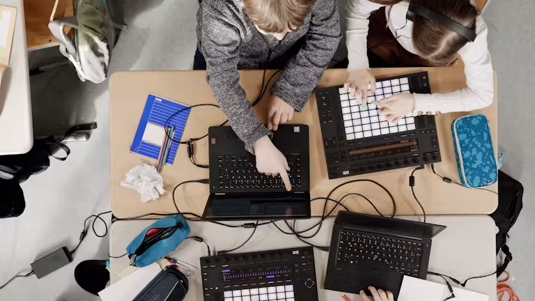 A student learns Ableton Push with a teacher (Ableton, 2021) A user learns Ableton Push with a teacher